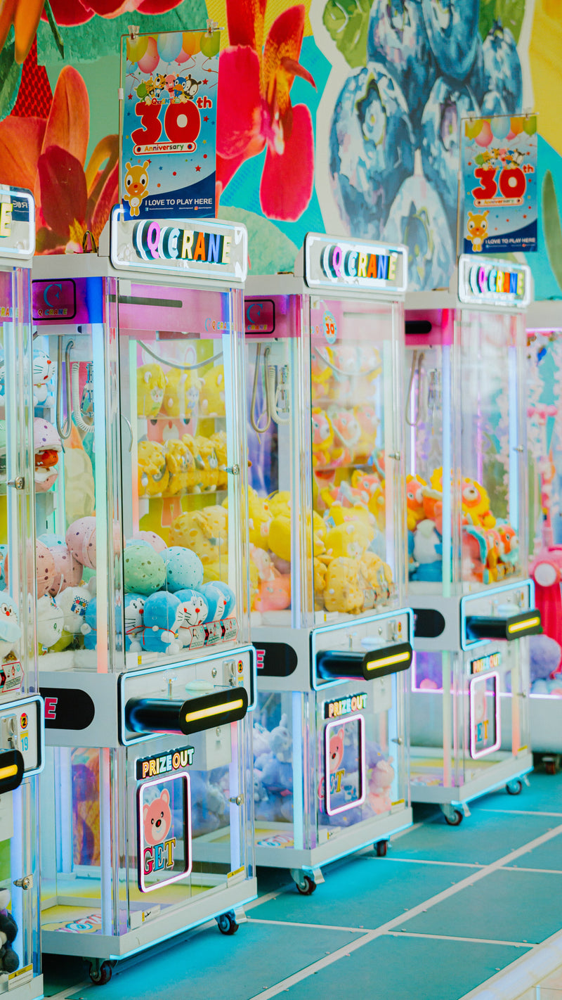 Claw machine with bright toys and arcade lighting